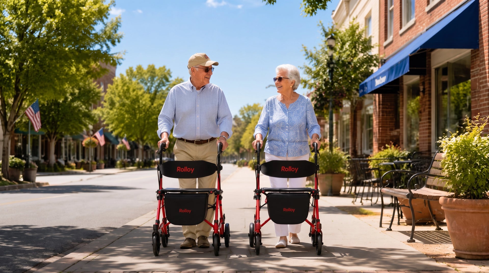 Senior couple walking outdoors with red Rolloy Compact Master II rollator walkers with seats and storage bags.